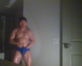 Oiled up and posing while wearing Speedos!