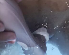 Jasmine masturbates the clitoris with a waterproof sex toy in the jaccuzy