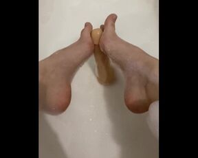 Sexy girl in the bathroom masturbating with her feet and herself