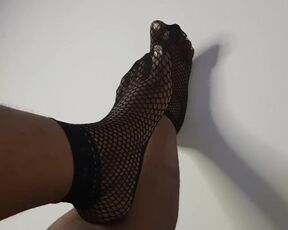 Just feet in fishnets socks tease